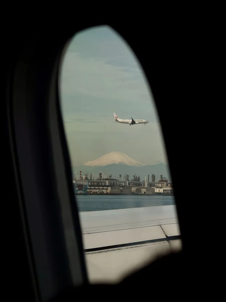 Mt Fuji and a Japan Airlines plane seen through an aeroplane window